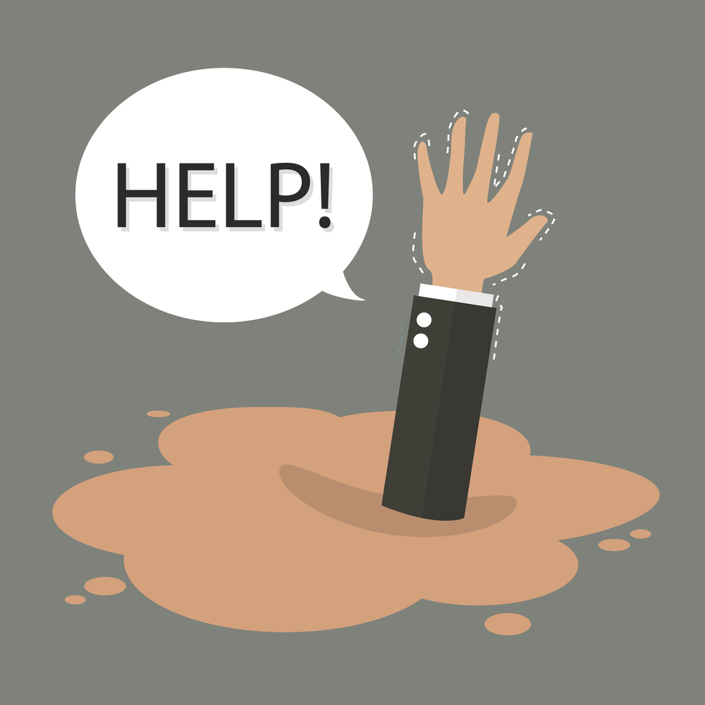 Businessman hand sinking in a puddle of quicksand. Business concept