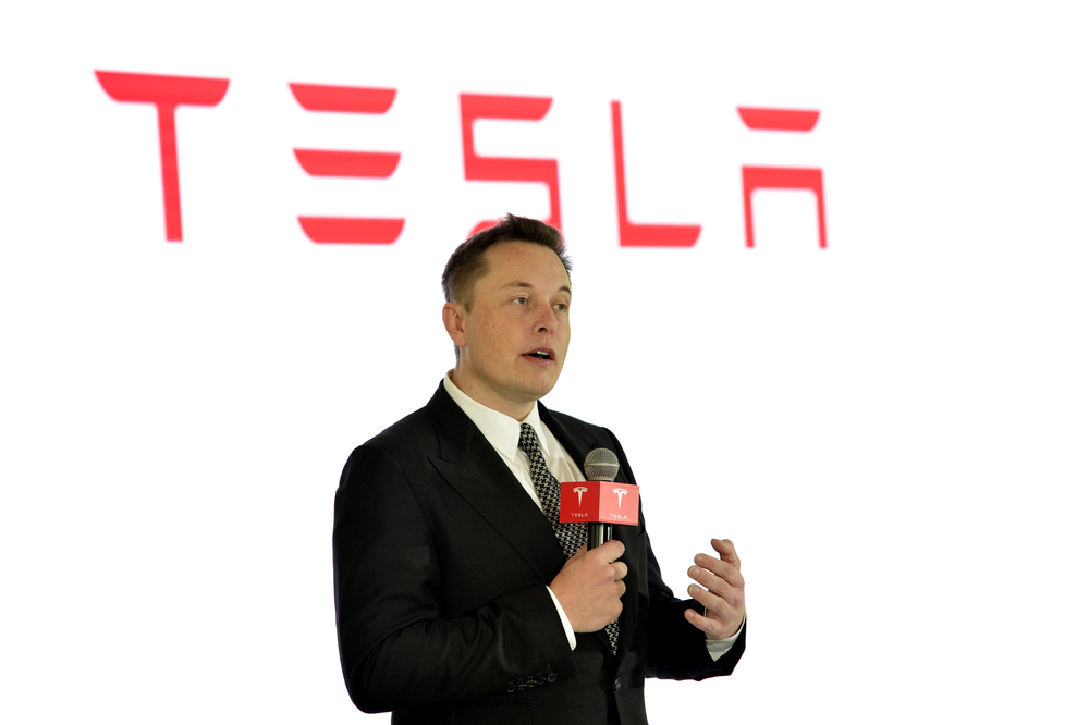 Tesla aims to build its electric cars in China Tesla CEO Elon Musk speaks during a press conference for Tesla Firmware 7.0 in Beijing, China, 23 October 2015.
Luxury electric-car maker Tesla Motors Inc. is in discussions with state and national government officials about producing its $76,000 and up vehicles in China, where the government is vigorously promoting reduced-emissions vehicles. The car maker said it hopes to make a definitive announcement resulting from those discussions soon. Chief Executive Elon Musk said local production could cut sales prices of Tesla cars in China by a third, thanks to reduced shipping costs and avoidance of import duties. He earlier in 2015 told official Xinhua News Agency that Chinese production could be possible "within three years." Mr. Musk's remarks were made at a forum on Thursday at Tsinghua University in Beijing.